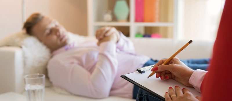 Man lying in couch during hypnotherapy